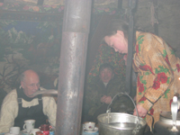 Women cooking for us, my Dad in background.