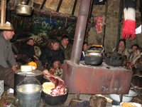 Woman fixing dinner, my dad is background.
